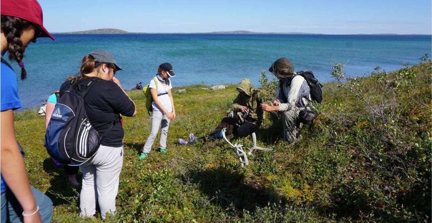 TSSRAP summer student Allison Wetrade exploring the Barren-lands, along with Tundra Science and Culture Camp students Photo:  GNWT / K.Clark, ENR