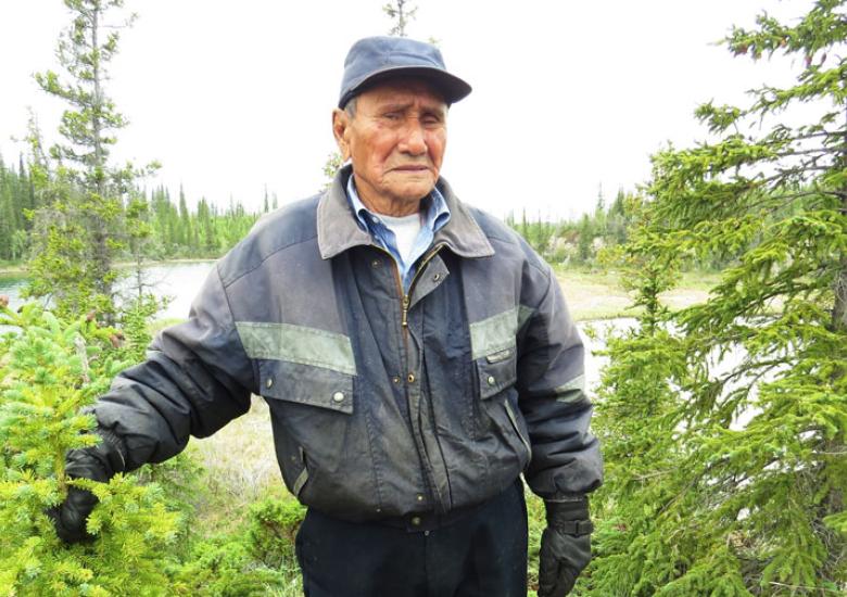 Elder Joe Champlain doing research fieldwork near Whatì  (Photo: Camilla Nitsiza)