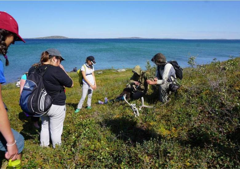 TSSRAP summer student Allison Wetrade exploring the Barren-lands, along with Tundra Science and Culture Camp students Photo:  GNWT / K.Clark, ENR