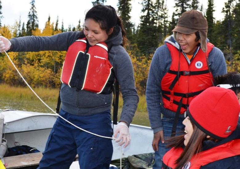 Youth trying sediment sampling equipment (Photo: Meghan Schnurr, WLWB))